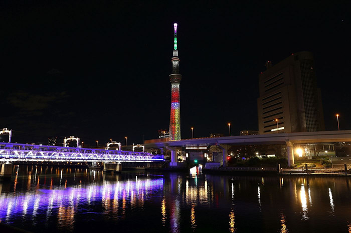 Tokyo Skytree lit up over the Sumida River at night